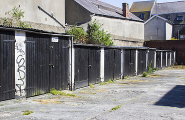 Fototapeta na wymiar A row of typical lock up rental garages with flat roofs in poor repair in Bangor County Down Northern Ireland
