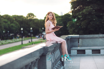 Young girl reading a book in the Park.