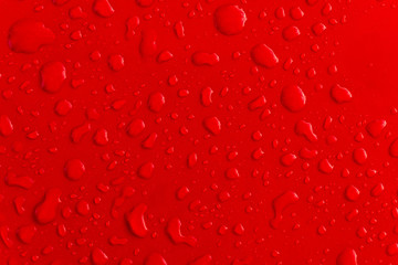 Red water droplet on the roof of car