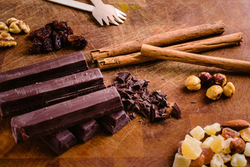 Plate of black chocolate chips with cinnamon and hazelnuts
