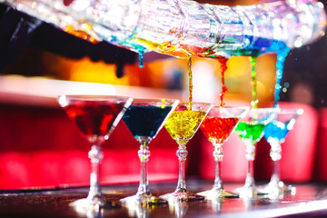 Barman show. Bartender pours alcoholic cocktails.