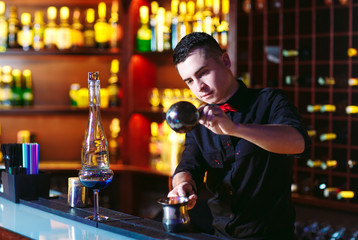 Bartender makes hot cocktail.