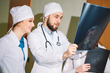 Doctors watching x-ray of patient.