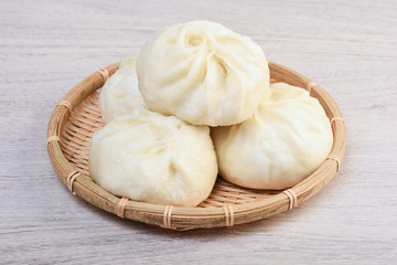 Fototapeta na wymiar Steamed stuffed buns on bamboo basket
