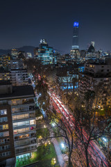 Amazing views of Santiago de Chile streets by night with the Andes mountain range full of snow...
