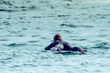 A beautiful girl at the beach with her bodyboard