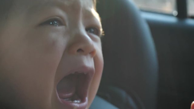 slow motion, baby crying unhappy in car seat