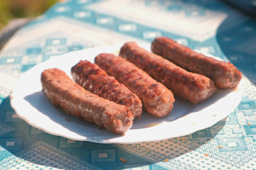 Sausages on a plate from the grill. Close-up.