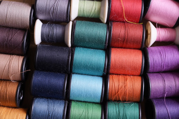 close up of colorful thread spools for background