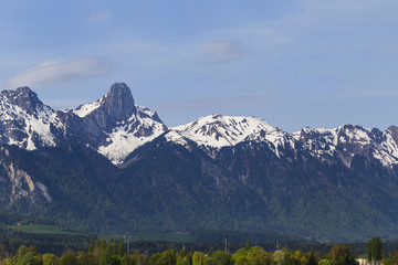 Stockhorn of Bernese Alps with lake Thun looking from street in village