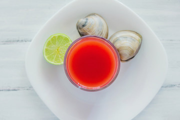 caldo de almeja, consome de almejas, clam cocktail with lemon mexican sea food in mexico