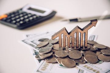 Graph icons placed on coins-Concept of business goals.