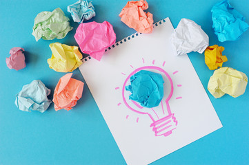 The drawing of a bulb on a white background. Idea, bulb, color crumpled paper.