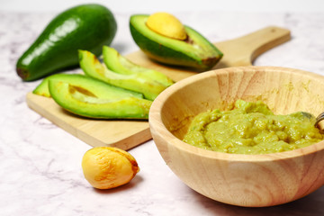 Guacamole sauce with avocado on marble table