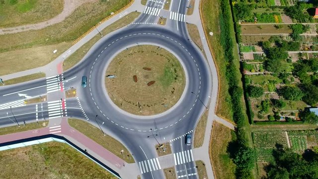 Roundabout intersection in three directions with island, aerial view