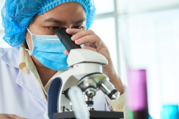 Scientist working with microscope