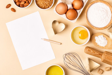 Ingredients and utensils for baking on a pastel background.