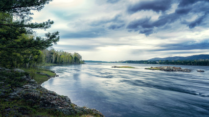The Yenisei River and the gloomy clouds coast forests