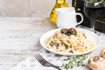 Fetuchini alfredo with mushrooms and chicken ham in creamy cheese sauce