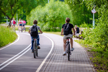     Cyclists ride on the bike path in the city Park 