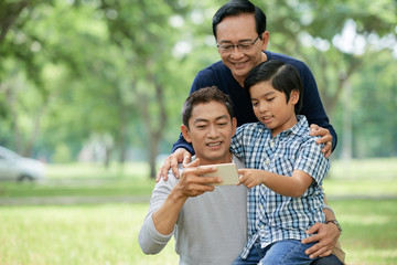 Cheerful family member exploring mobile app