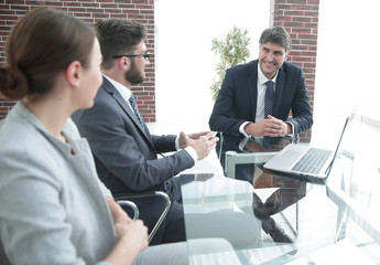 positive manager with his team sitting at the table