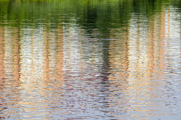 Reflection of a brick building on the lake as an abstract background