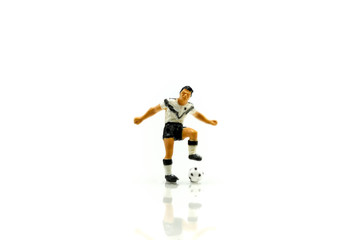 Fototapeta na wymiar Miniature people : Soccer player man,football world championship cup concept.