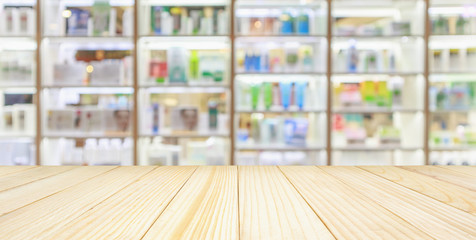 Pharmacy wood table counter with medicines healthcare product arranged on shelves in drugstore...