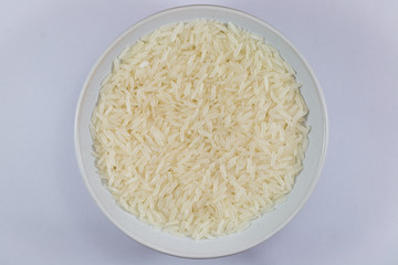 white rice whole grains in bowl isolated