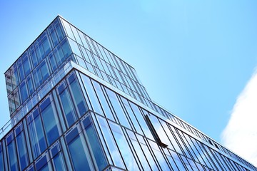 Fototapeta na wymiar Blue clean glass wall of modern skyscraper