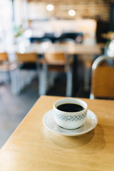 Coffee on the wooden table with plenty of natural light