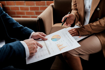 Business concept. Business people discussing the charts and graphs showing the results of their successful teamwork.