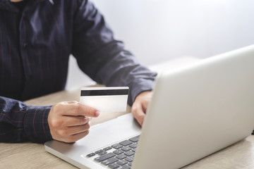 man using credit card shopping online with laptop, payment and marketing concept