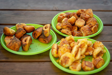 On the picnic table there are three green plastic dishes with different pies.