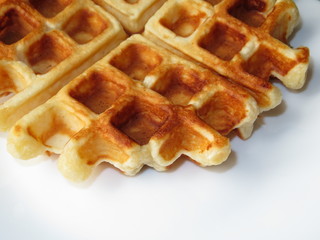Belgian waffle isolated on white plate. Homemade breakfast