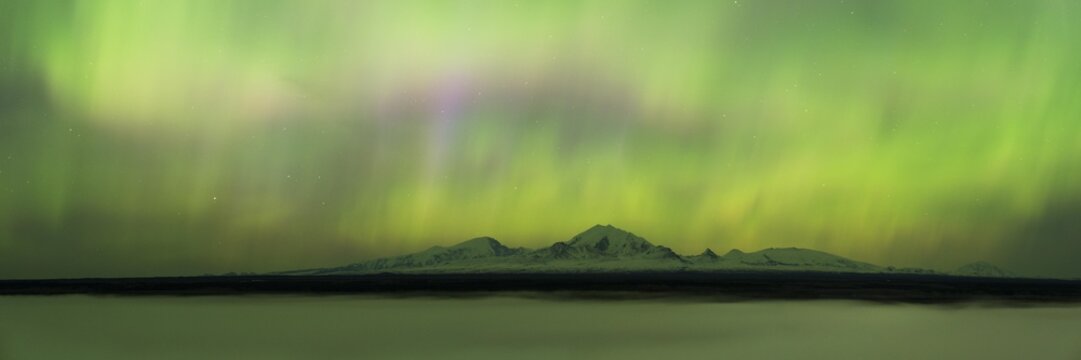 Aurora over the fog shrouded Copper River and mounts Sanford Drum and Wrangell, Copper River, Wrangell Mountains, Alaska