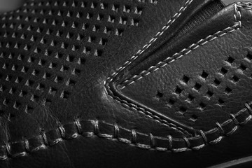 Natural black leather with perforation in form of the rhombus. Stitched parts of the shoes,...