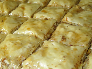 Baklava with walnuts isolated on a white plate. Traditional turkish and arabic dessert rectangle shape made of layers of filo