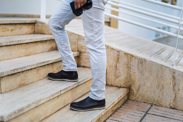 low section of a man walking up stairs