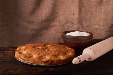 apricot pie and a bowl with flour and other ingredients and tools table