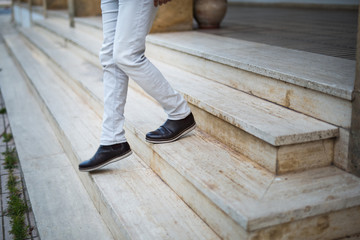 low section of a man walking down stairs