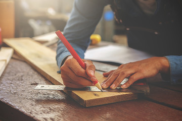 Carpenter working on woodworking machines in carpentry shop. woman works in a carpentry shop.