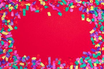 Festive party decor and confetti on pink background