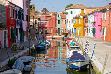 Breathtaking historic multicolored Venetian houses heat up in the summer sun.