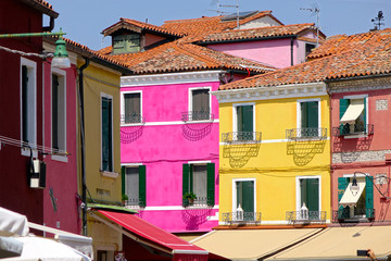 Spectacular shot of cool white framed windows of colorful houses in Burano.