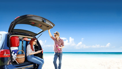 Summer trip on beach. Big blue car with two people. Free space for your text. 