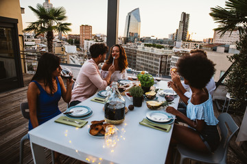 Group of friends having fun on the rooftop of a beautiful penthouse - obrazy, fototapety, plakaty
