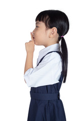 Asian Little Chinese Girl putting finger up to lips and asking for silence