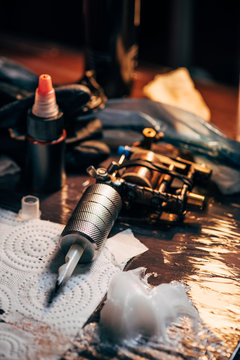 close up view of tattoo machine, ink and other equipment for tattooing process